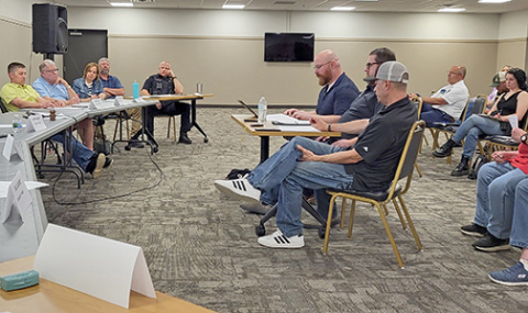 Members of a citizens focus group (seated at center table) present their findings during a report to the Aurora City Council at a May 26 meeting which drew approximately 40 people to the Bremer Center.