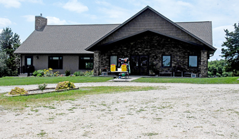 The original lodge building at CRC was replaced by this new one 12 years ago, which has given the facility more room for indoor activities on hot summer days. A rack with the campers’ lunch bags stands out front. 
