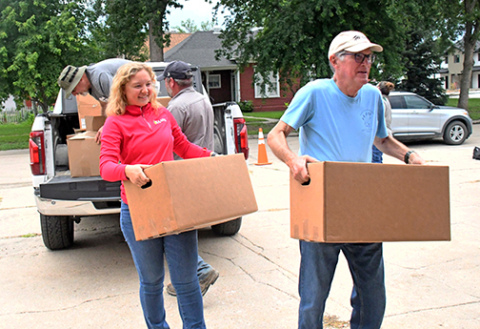 Volunteers carry food donations into the food pantry during last week's Can Care-A-Van
