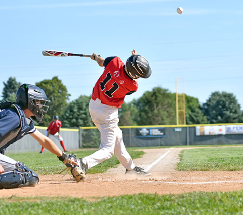 Jack Carstensen connects with one down the left field line duirng a game earlier this season for the Aurora Cooperative Juniors team. 