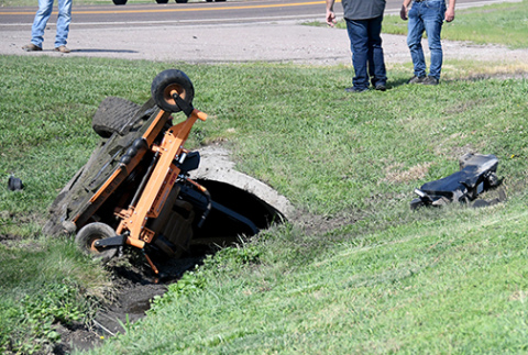 This mower operated by a Hampton maintenance worker came to rest near this culvert Tuesday after it was struck by another vehicle.