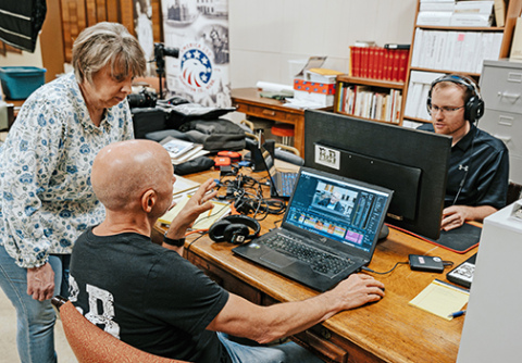 Tina Larson works with filmmakers Brian (left) and Connor Kreikemeier during the editing of the documentary “Hamilton County: This is US!” 