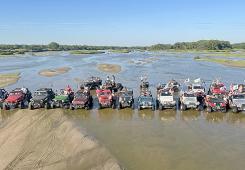 The water level in this picture of a group of River Rats enjoying a day on the river is almost too low for maximum jeeping enjoyment, according to River Rats President Jake Brown. He says members like a water flow of about 1,200 cubic feet per second so that riders can be in the water to cool off on a hot day. 