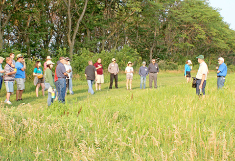 David Vetter (right), CEO of Grain Place Foods, leads a tour of the organic farm near Marquette during a Field Day in 2023. Tours of both the farm and the processing facility will be part of the morning session of the 2026 Field Day on July 18. 