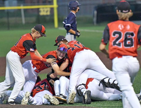 The Aurora Cooperative Post 42 Juniors team celebrate after winning the Class B Area 4 district championship Tuesday night in York. 