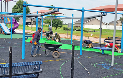 A crew works to install the special rubberized play surface at the Hamilton County Inclusive Playground