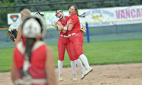 Novella Stevens (far right) and Vivi Fahrnbruch celebrate a defensive double play during Aurora’s 5-2 win over Auburn Friday. Stevens would later blast her first home run of the season against Malcolm. 