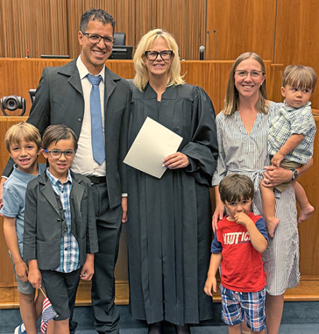 The Edwin Gomez family poses for a picture with Federal Judge Susan Bazis following the July 17 ceremony in Lincoln in which Edwin and a group of others were sworn in as U.S. citizens. Included in the picture are Gomez’s wife, Allie (Mitchell) and their four sons, from left: Benji, Zeke, Eliseo and Zeb. 
