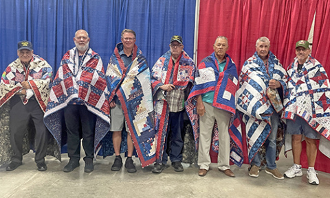 Seven Hamilton County veterans were honored with Quilts of Valor at the Hamilton County Fair on Sunday. Pictured from left are James Garfield, Barry Horner, Jim R. Nachtigal, Harold Skidmore, Arlie Johnson, Dale Quick and Cody Quick.