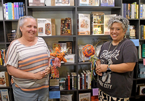 Espressions co-owners Lisa Montoya (left) and Maile Ilac Boeder show off some of the new books and other items that have been added to the newly renovated shop.
