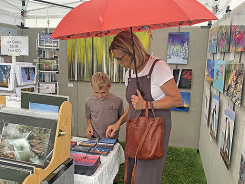 Shoppers browse a booth at last year's Art Walk Aurora.