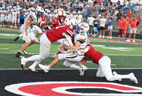 Aurora seniors Hudson Decker, left, and Malakai Camacho smother Seward running back Carter Hanes in the end zone for a second-quarter safety. The Huskies led 22-3 at the half and pulled away for a convincing 43-10 win in a return to Class B football.
