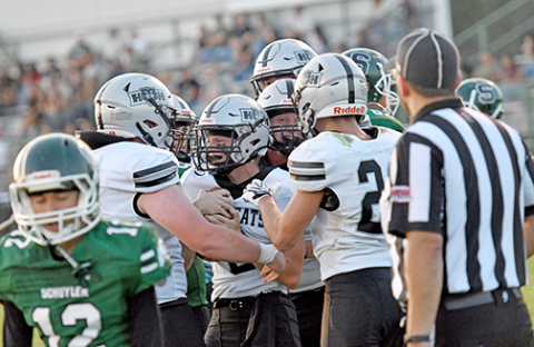 H&H quarterback River Glinsmann is mobbed by his offensive linemen after scoring a rushing touchdown in a 43-0 win over Schuyler Friday night. 