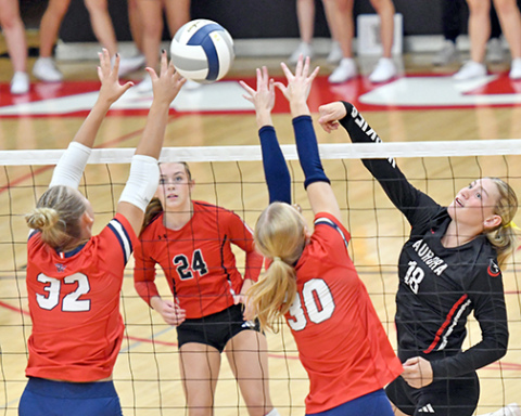 Paisley Bartek pushes an attack past two Adams Central defenders during Aurora’s three-set loss to the Patriots at home Sept. 15.