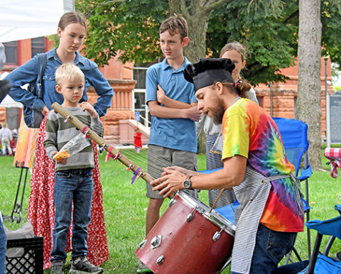 Art Walk Aurora featured over 30 artists at the Hamilton County Courthouse lawn on Sunday with patrons of all ages getting a chance to see and buy the various art pieces on display. Casey Hollingsworth, the inventor of The Music Kitchen, showcases an instrument he made inspired by the Kora, a stringed instrument traditionally made in West Africa.