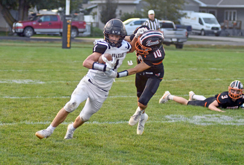 Ben Gordon wrestles down Ansley-Litchfield’s Owen Brott during Giltner’s 44-38 wild Homecoming win Friday. Gordon had seven tackles in the game that featured a three-hour weather delay. 