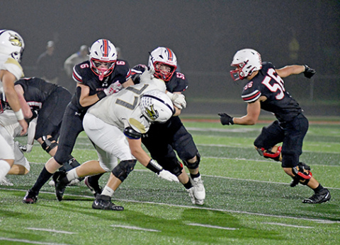 The offensive line cleared some huge holes Friday against Grand Island Northwest, as shown here with Dylan Ronnau (6) and Jake Molliconi (52) taking Aidan Deneui out of the play. Ryan Carlson (56) is shown at right looking for someone to block.