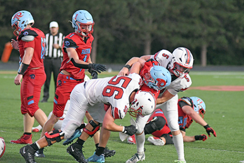 Aurora senior Ryan Carlson made his season debut Friday, getting in on an assisted tackle here with teammate Wyatt Pollet.
