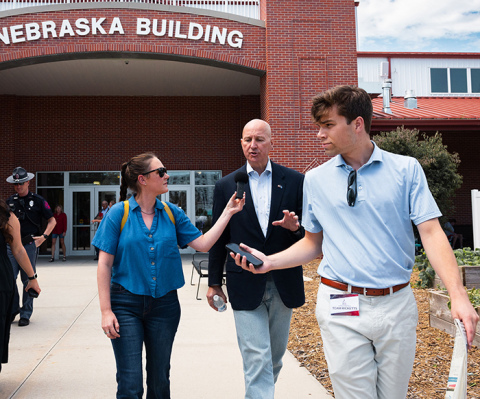 Jesse Harding Campbell, pictured at left, conducts an interview with Sen. Pete Ricketts while walking through the Nebraska State Fair. Campbell, founder of Marsh Wren Creative, recently moved with her family to the rural Phillips area.