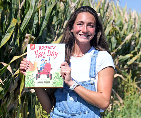YouTube creator Laura “Laura Farms” Wilson displays her children’s book, “Roger’s Hay Day” that will be released next month. The book was created in collaboration with FFA to introduce young children to different fields in agriculture. 