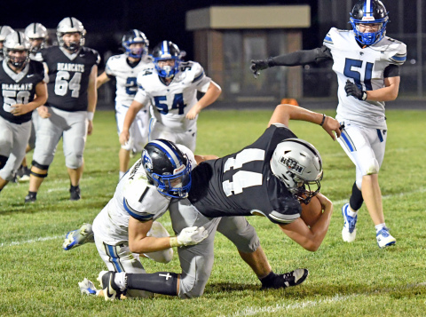 Jagger Regier reaches for the first down line in H&H's 30-0 loss to Hershey Friday. 