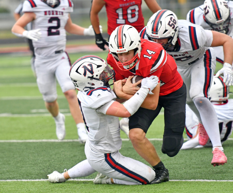 Sam Jones runs through a Norris defender during Aurora's 30-21 win Saturday afternoon. 