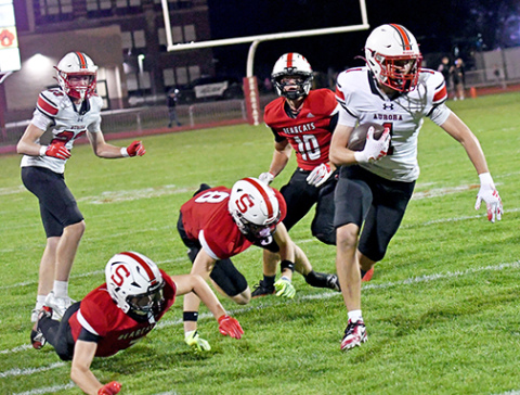 Landon Danhauer eludes multiple Scottsbluff defenders, scoring the game’s first touchdown in Aurora’s 24-21 loss to the Bearcats Friday. Danhauer caught two touchdowns in the game, totaling 77 yards. 