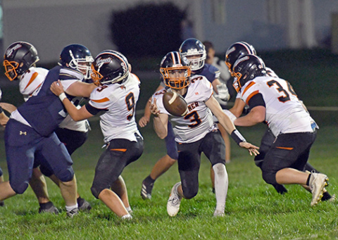 Giltner QB Brody Rudy pitches the ball on an outside run play near the goal line during the Hornets’ 62-50 loss at Grand Island Lutheran Thursday. 