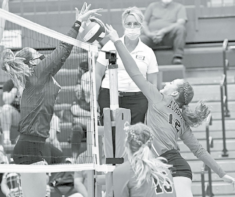 Rachel Hunter fights for control at the net during second set action against Wahoo Thursday. The Lady Huskies lost in three to the Class C-1 preseason No. 1 team. News-Register/Richard Rhoden