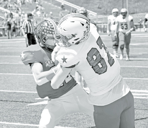 Husker walk-on and Shrine Bowl South tight end Nate Boerkircher wrestles a jump ball away from North’s Tyler Stauss for a touchdown Saturday. News-Register/Richard Rhoden