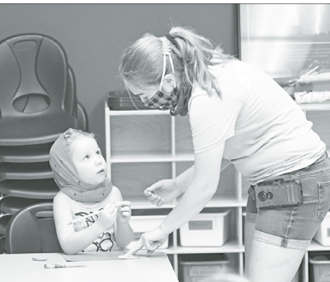 Young Harper Dunn works on tracing out a project for a hair beret during Mermaids and Unicorn camp at the Edgerton June 18. News-Register/Richard Rhoden