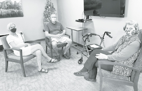 Memorial Community Care resident Rosie Reisinger, right, enjoys her first visit in four months with family members. Pictured at left are Rosie’s daughter and son-in-law, Martha Sue and Dayne Brehm. Courtesy photo