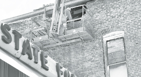 Work crews have been busy repairing a damaged portion of the east wall of the Jones Building, where bricks had fallen away in late January causing damage below. News-Register/Kurt Johnson