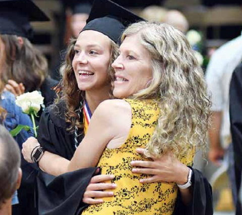 Giltner senior Sydney Janzen (left) and her mother, Debbie, grin the cameras during Giltner’s information on th graduation ceremony Sunday. News-Register/Richard Rhoden