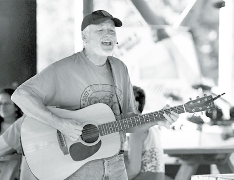 Lincoln musician Paul Siebert roamed the crowd while performing Saturday night in Stockham. News-Register/Kurt Johnson