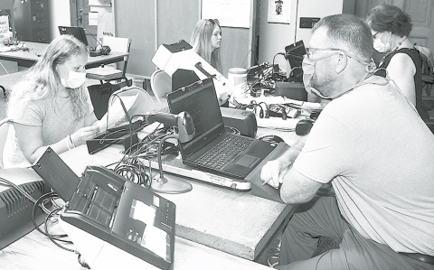 From left, Lillian Dose and Aubrey Garfield take their driver’s license exams at the Hamilton County Courthouse with examiners Mike Thomas and Jen Sola. News-Register/Kurt Johnson