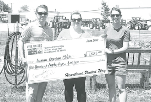 Pictured from left: Kurt Johnson, president of the United Way Hamilton County Committee presents a $1,025 Community Impact check for the Heart Beets Community Garden to April Vetter and Sarah Lyon. News-Register/Jeni Moellenberndt