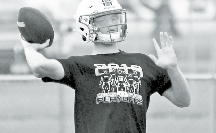 Above: Aurora quarterback Ethan Shaw lets one go during the Huskies’ first practice of the 2020 season Monday morning. At right, Gage Griffith goes through an offensive lineman drill during the first day of practice. News-Register/ Richard Rhoden