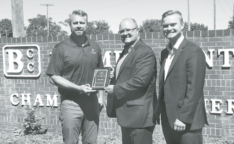 From left, Curran Vetter hands Shane Thorell a plaque thanking him for 11 years of service on the Bremer Center board of directors, eight as president. At right is Trevor Thorell, who stepped in to fill his father’s seat on the board. News-Register/Jeni Moellenberndt
