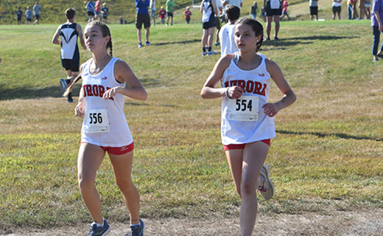 Kaitlyn Oswald (left) and Natalie Bisbee set their pace at the beginning of the Seward Invite. News-Register/Jeni Moellenberndt