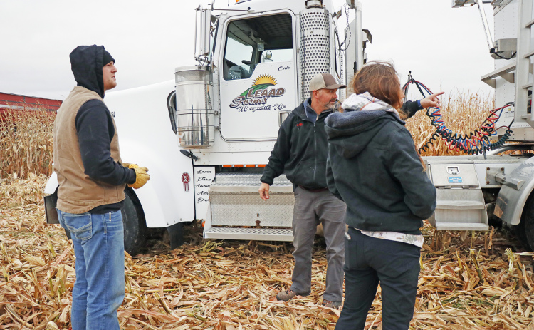 Grant Wilson (left), Cale Carlson and Laura Carlson made sure they had their trucks in the best spot to meet up with the grain carts Friday morning near McCool Junction.