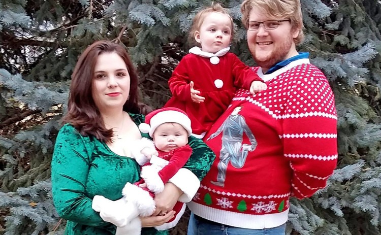 Sylvia Painter stand with her husband Brendon, daughters Morgan and Felicity and their “store mascot” Trigger.