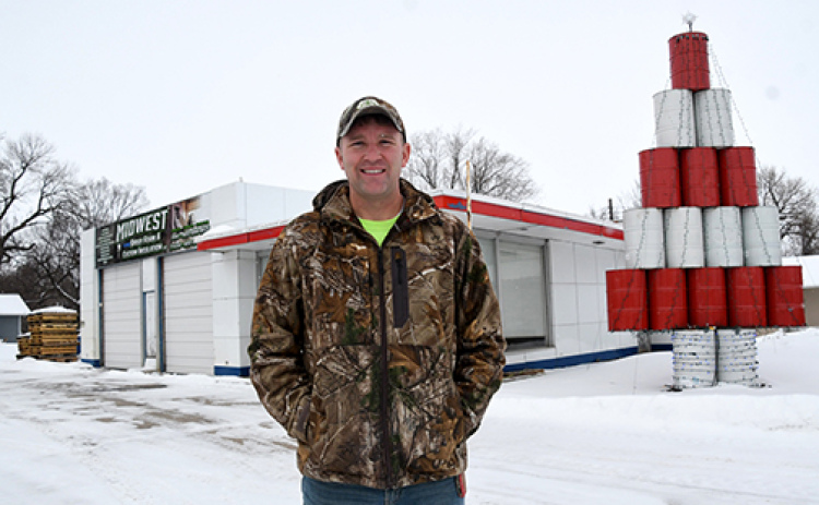 Eric Joseph stands in front of the Highway 34 structure where he currently bases his Midwest Spray Foam business. Joseph is planning to tear down the former gas station when the weather allows and build a new structure in its place.