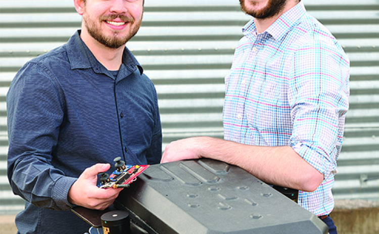 Ben Johnson, left, and Zane Zents show the latest model of the Grain Weevil, which earned them a prestigious MIT prize.