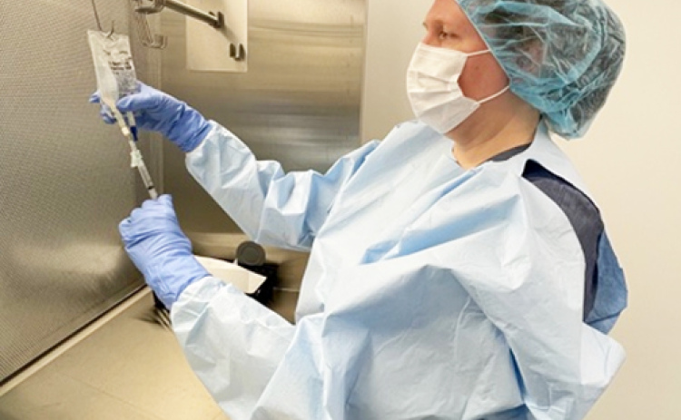 A major upgrade to the hospital pharmacy is the focus of fundraising for MCHI’s Stay@Home Gala. Pictured here is MCHI’s Director of Pharmacy Nicole Dvorak, demonstrating the use of one of two new Primary Engineering Control (PEC) units, also known as “IV hoods.”  The PECs purchased include a biological safety cabinet for hazardous preparations, such as chemotherapy treatments, and a laminar airflow workbench (pictured) for the preparation of non-hazardous drugs such as IV antibiotics...
