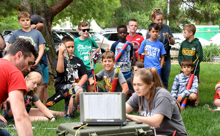 Edgerton staff members Nichole Havlik, right, and John Boeder, use a high-tech camera to show youth campers shooting images captured using ultra high-speed photography.