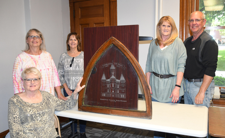 Members of the Courthouse 125th Anniversary Committee pictured with an old window from the courthouse etched with a special logo include, from left: Karen Bamesberger, Becky Richter, Nancy Thomas, Tina and Bill Anderson. Not pictured are Scott Stuhr and Nancy Salmon
