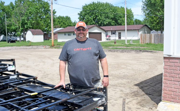 News-Register/Kurt Johnson Scott Snider stands on the Snider’s Outdoor Power property on Highway 14. The existing structure is to the right, and behind him is a leveled site where a 63-by-35 foot addition will soon be built.