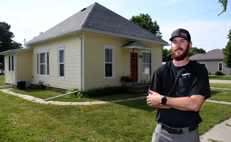 Nic Lewis is shown outside “Sunflower Cottage” on H Street in Aurora, which debuted on Airbnb as a local housing option in April.
