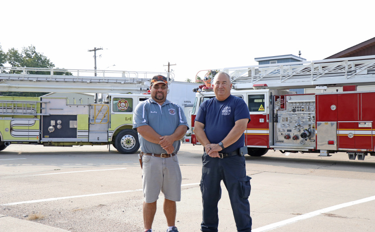 Hamilton County will now be served by two ladder trucks at the Aurora and Giltner fire departments. Aurora passed off its green 65-foot ladder truck to Giltner Fire Chief Brad Consbruck (left) last week, and Aurora Fire Chief Tom Cox welcomed a 100-foot ladder truck to the Aurora fleet.